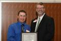 Erik Andrews winner of Outstanding M.Ed. student in Physical Education receives his award from Dr. Layne