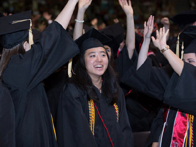 Debbie Harwell, Ph.D being hooded by Dr. Storrs