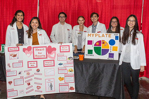 Students with health posters at an event