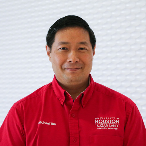 Portrait of an Asian man smiling wearing a red button-up shirt