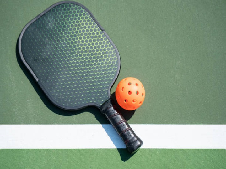 Pickleball and paddle on court