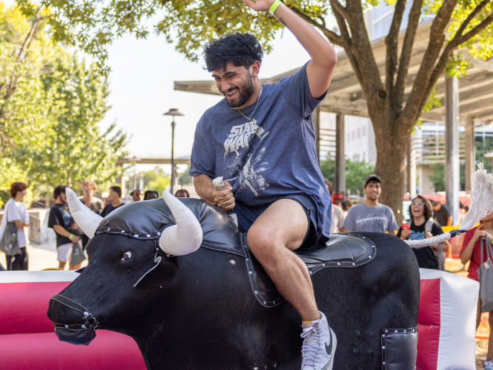 Person riding fake bull.