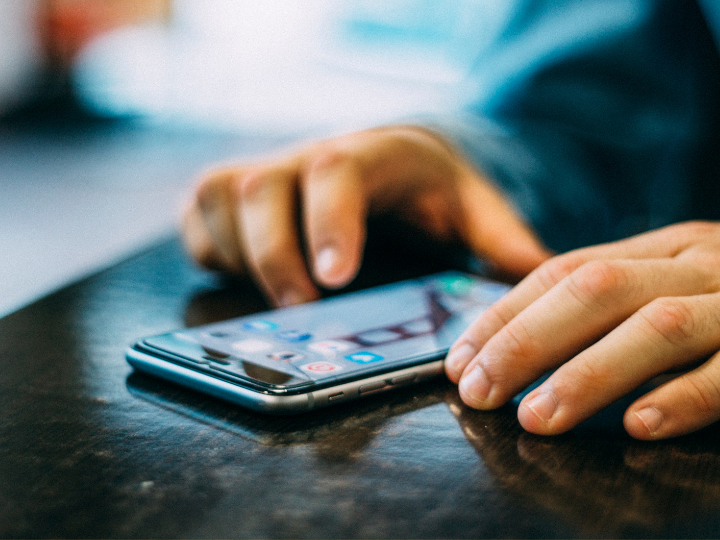 Zoomed in image of Cell phone and hands