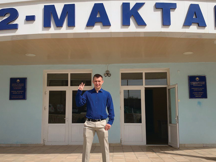 Man stands in front of a building in Uzbekistan