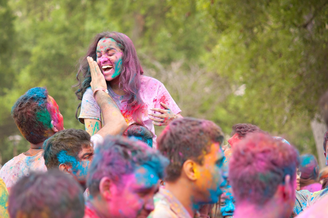 People covered in colorful dust to celebrate Holi