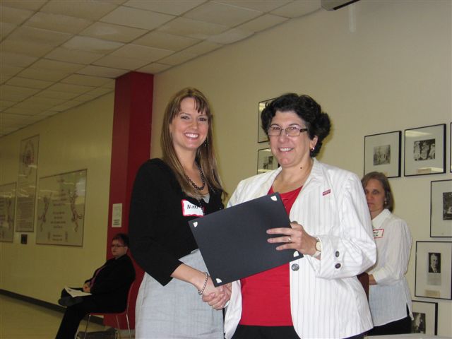 Laura “Nikki” Achivida receiving her ComD Scholar Certificate from Dr. Lynn M. Maher, Chair of ComD.