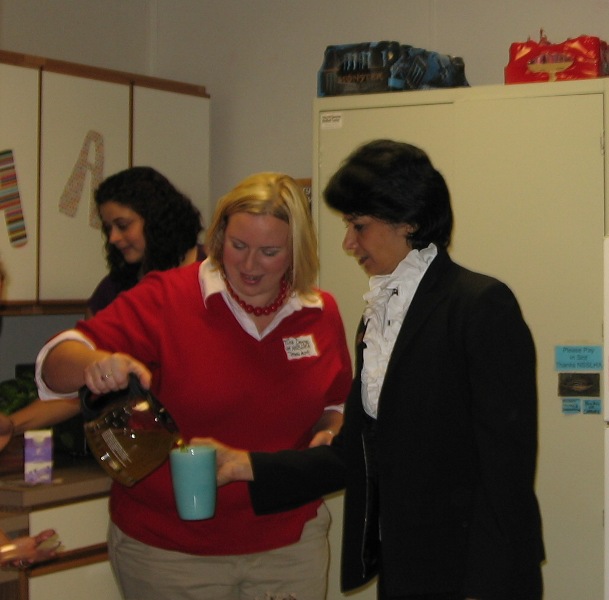 President Khator enjoys a cup of tea offered by Tina Degge, an undergraduate student and NSSLHA member