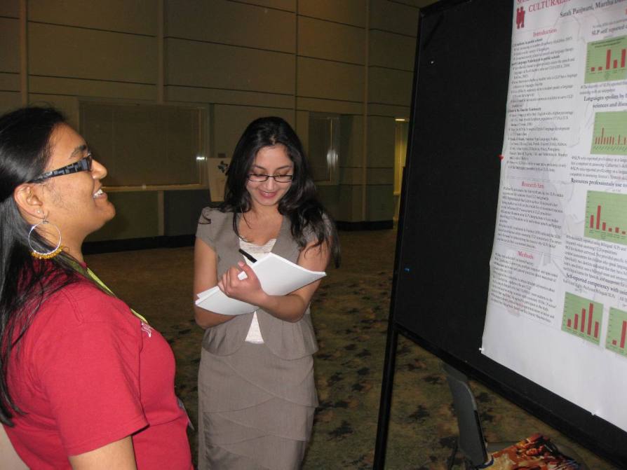 UH undergraduate student, Sarah Panjwani, discussing her poster