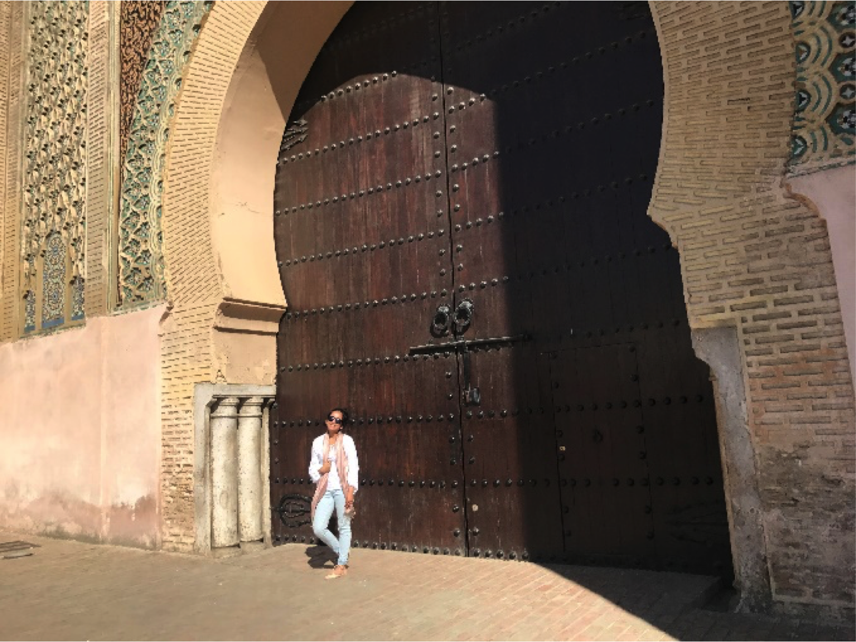 Ms. Uddin in front of Moroccan door