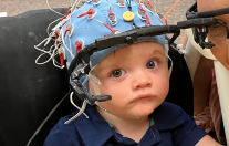 Child wearing EEG cap and head camera