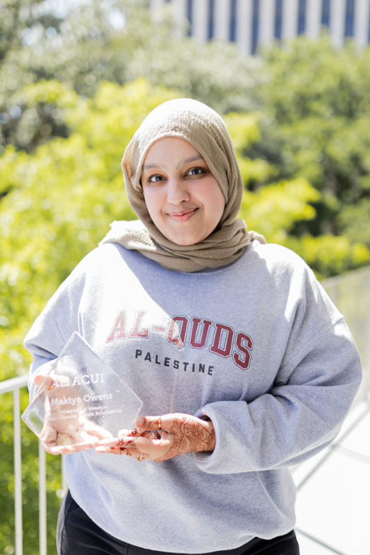 Sarah Khan holding award