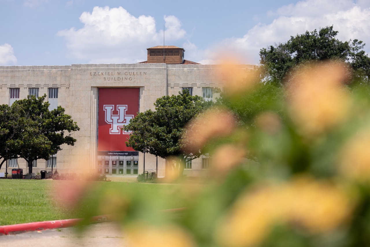UH's E. Cullen Building with flowers out of focus in the foreground.