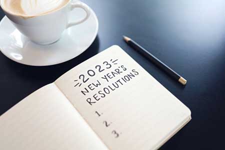 A notebook with an empty list below the heading "2023 New Year's Resolution".