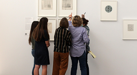 Students looking at art on the wall