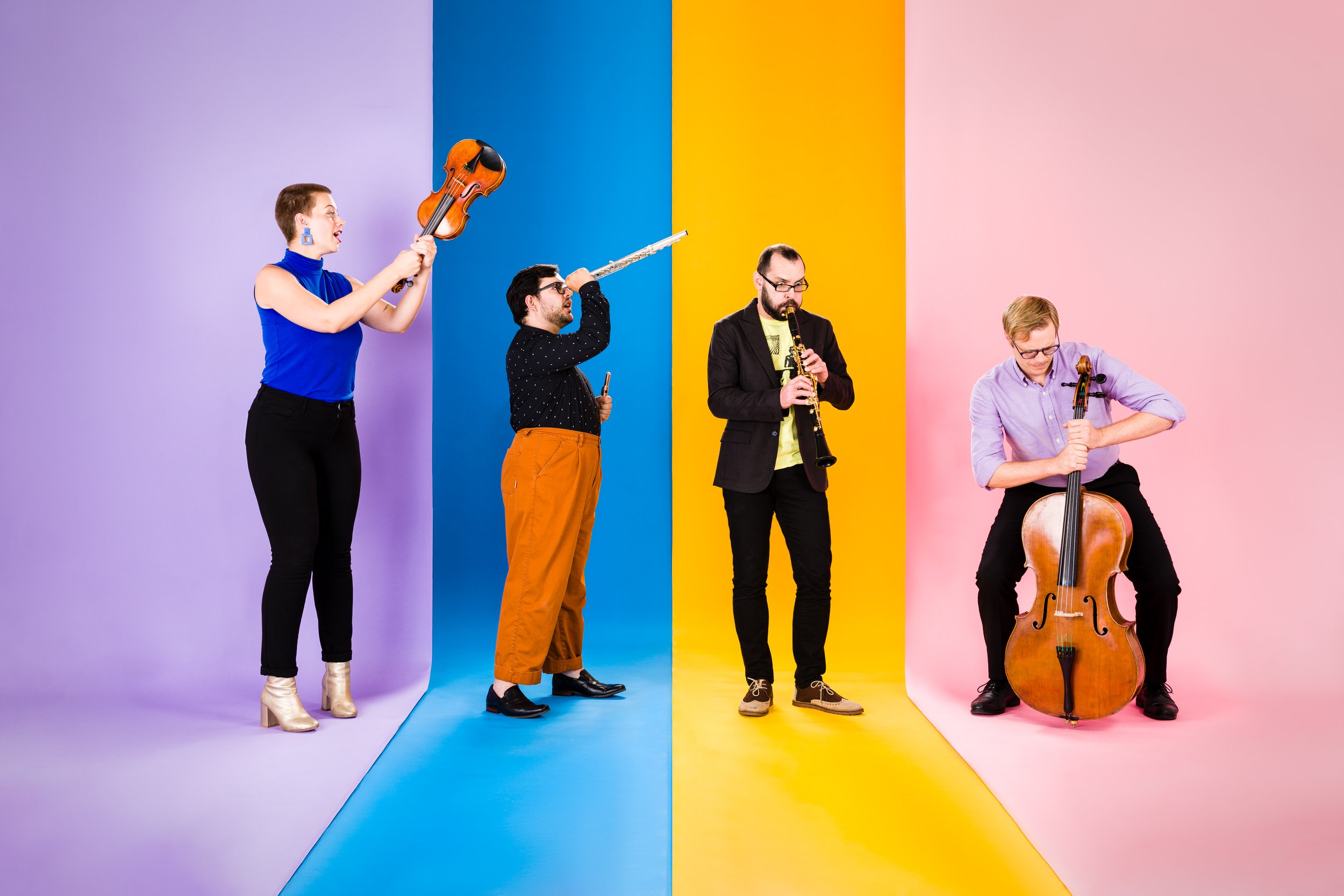 The members of HUB New Music perform their various instruments against a colorful, segmented background.
