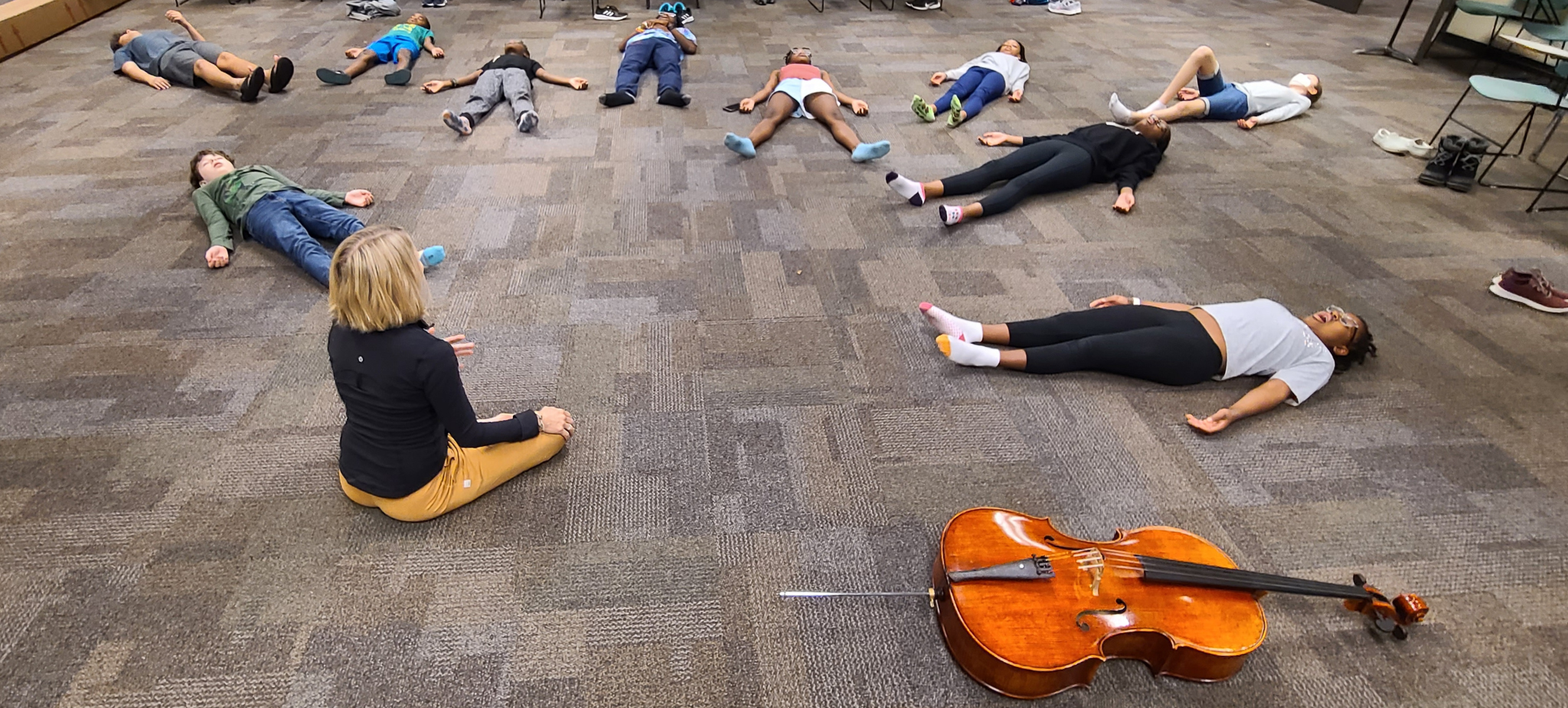 Group photo of young musicians at a "University Adventure" yoga class