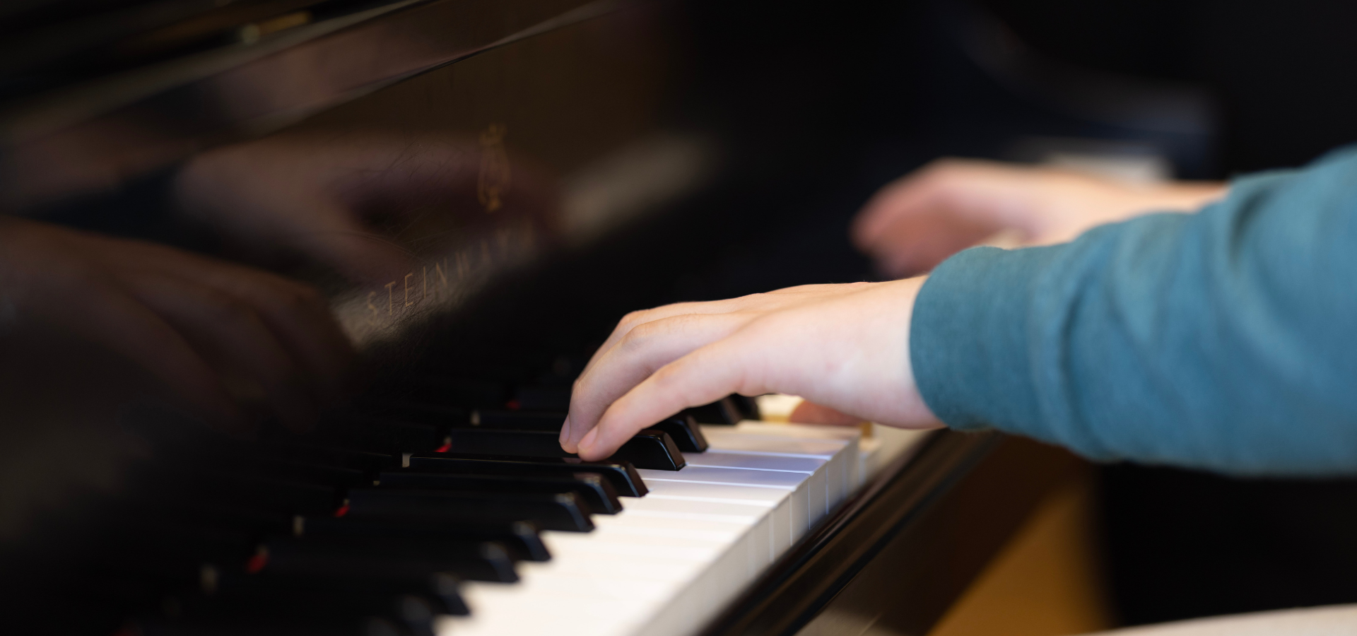 a closeup of someone playing a steinway piano