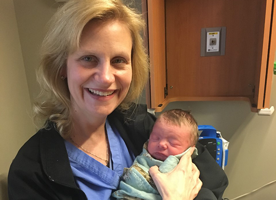 Dr. Pilkinton with a newborn