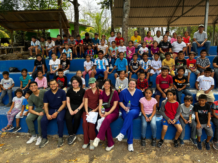 Medical Students participating in the Honduras mission posing with members of the local community.