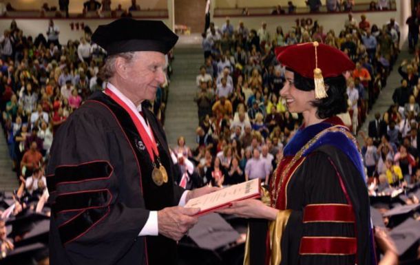 Wilson recieving honorary degree from UH president Renu Khator.