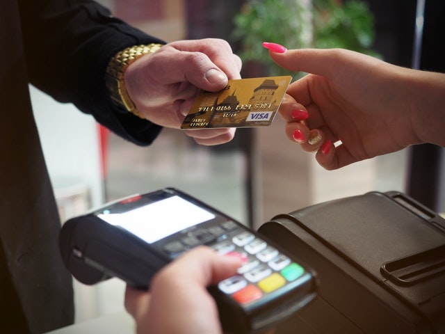 Photo of customer paying for purchase with credit card