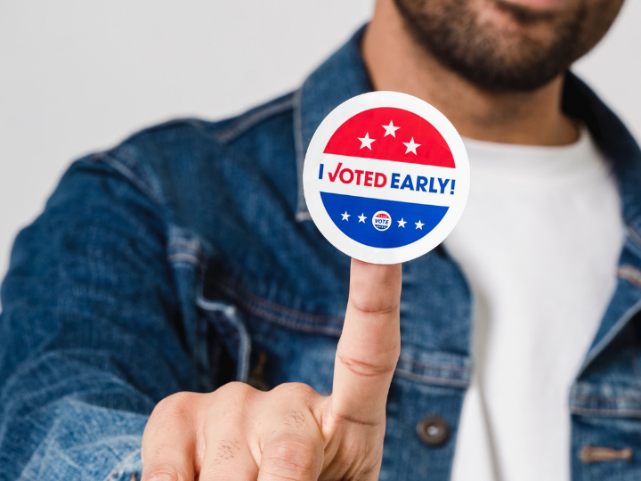 Photo of young man with sticker saying I voted early