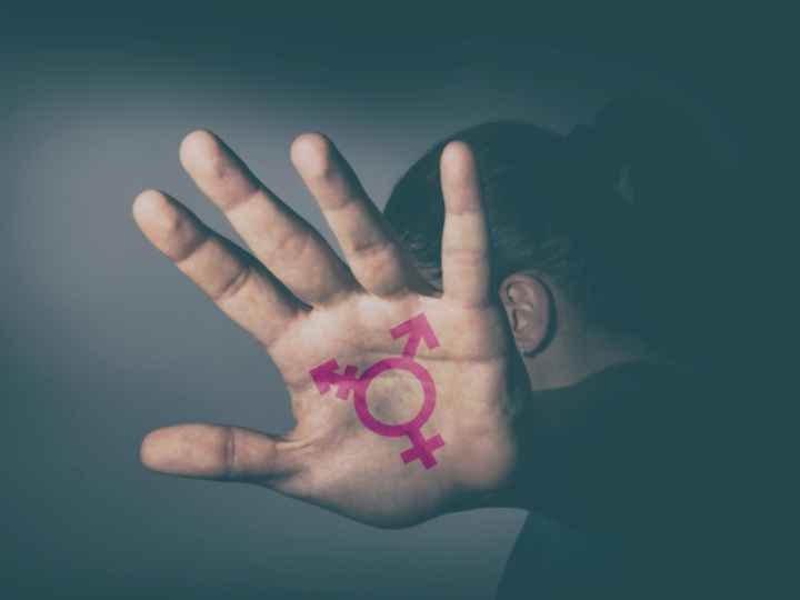 Photo of hand with transgender symbol painted on palm