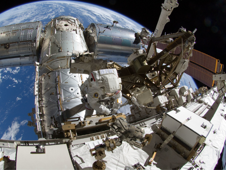 astronauts working on satellite