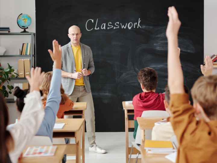 Photo of a teacher and students in a classroom