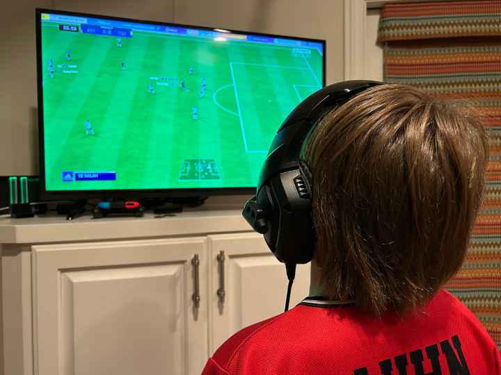 Photo of young boy playing a video game
