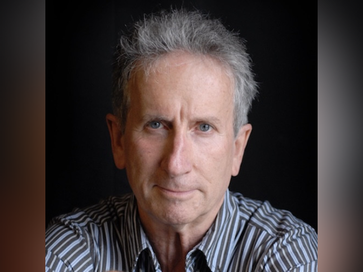 Image of Stephen Montague with black background behind him