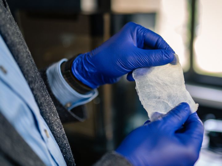 Rahman holds the bioplastic, made of bacterial cellulose