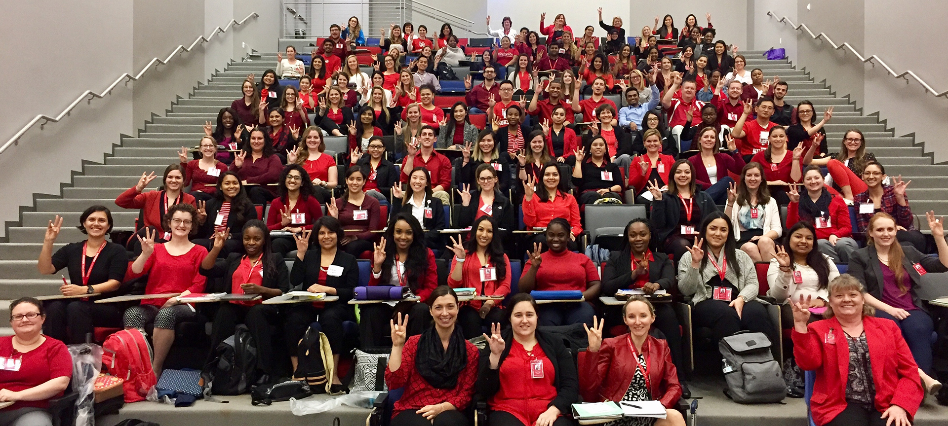 Nursing faculty and students sitting together in an auditorium