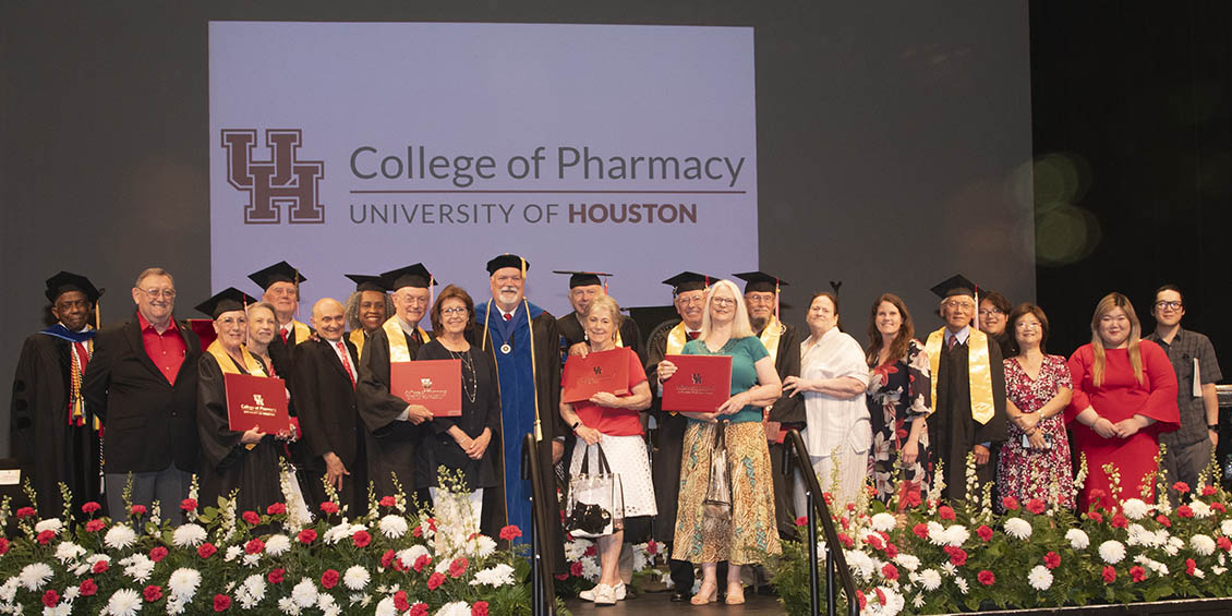 group photo of Golden Cougars and others on stage