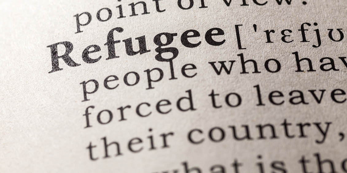 A close up of the word 'refugee' in a dictionary.