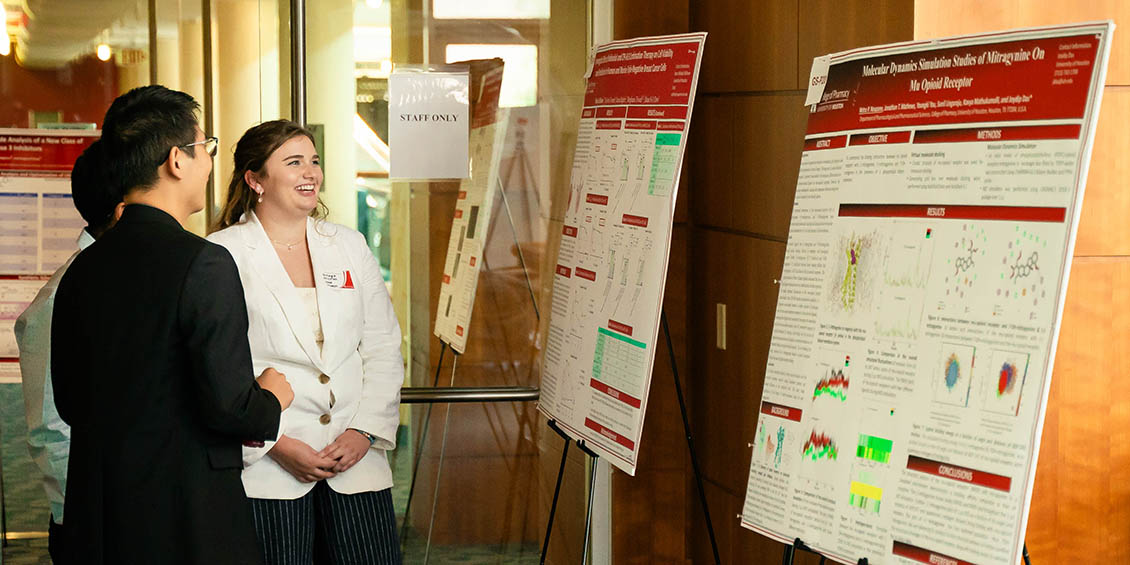student at poster laughing with judges