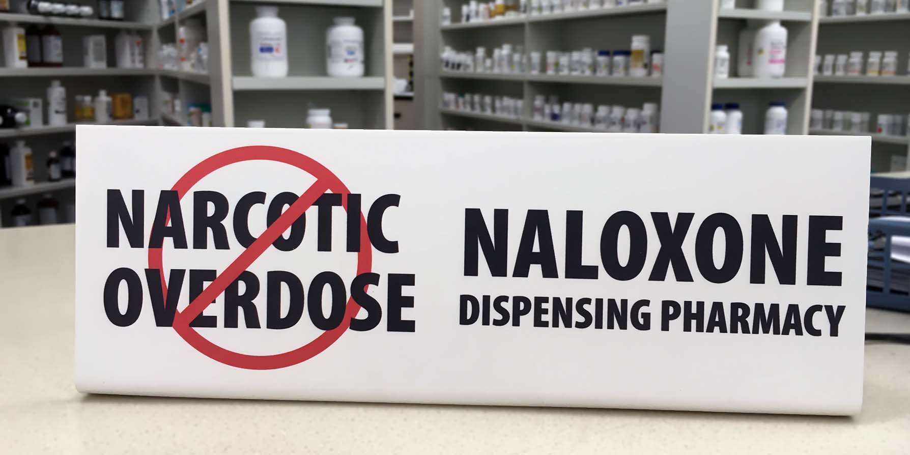 naloxone sign at pharmacy