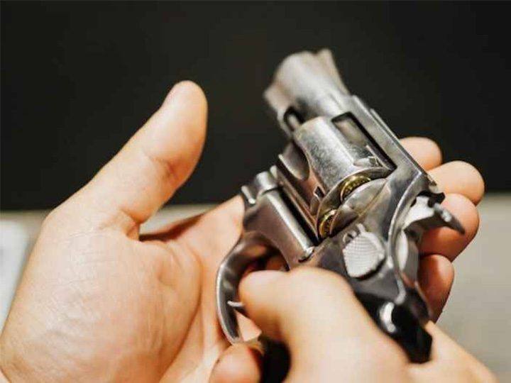 close up of pistol in a person's hand