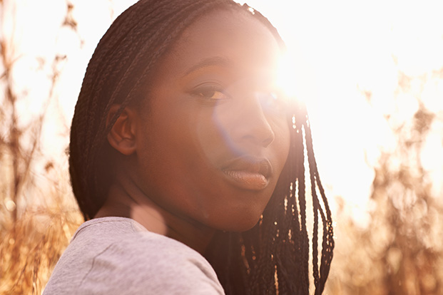 Black teenager in a field