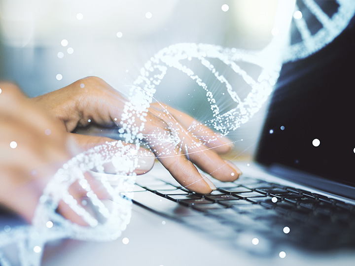 close up of hands typing on laptop with illustration of dna strand overlay