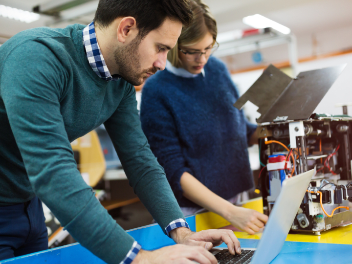 two students work together on a project in a lab