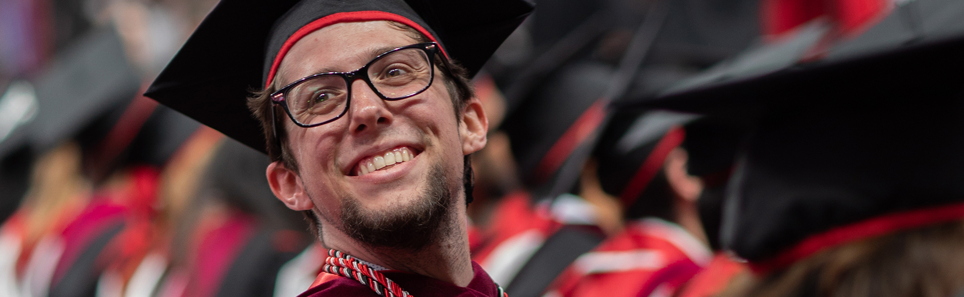 Graduate smiling at commencement ceremony