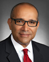 Portrait of man wearing glasses in a suit