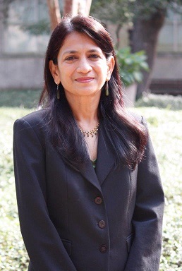 Portrait of a dark-haired woman wearing a dark grey suit
