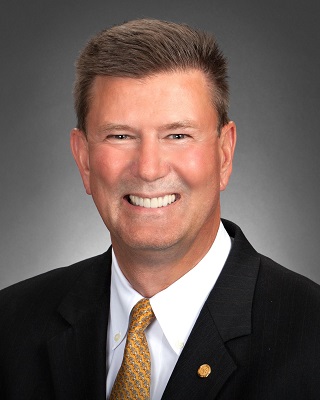 Portrait of a man smiling wearing a suit