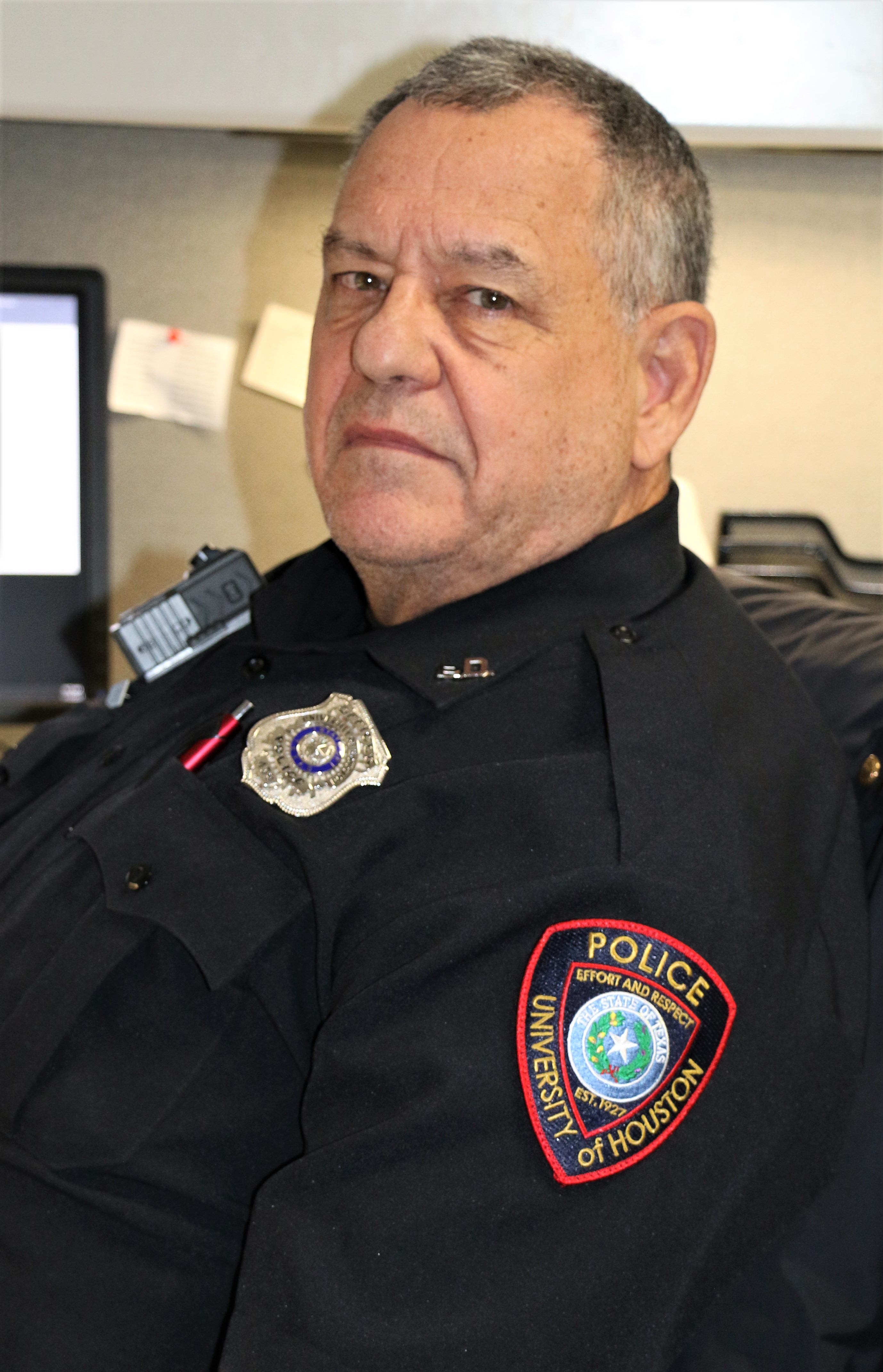 Portrait of a man with short grey hair in a UH police uniform