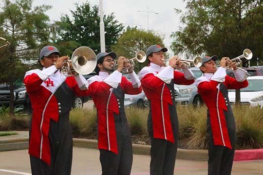 UH band members playing horn instruments