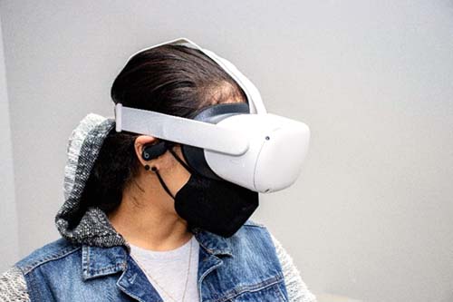 A student wears a white virtual reality headset.