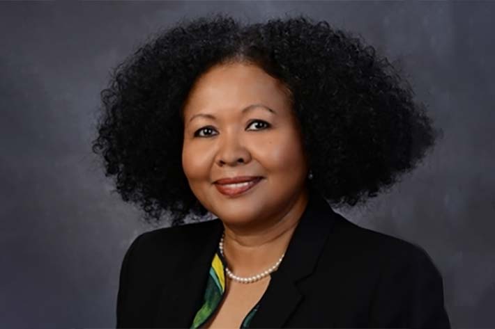 Portrait of a Afro-Latin woman wearing a black business jacket