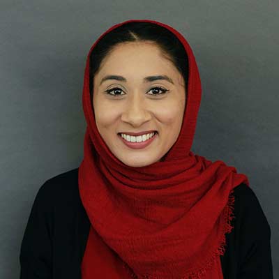 Portrait of a woman wearing a red hijab and a black top
